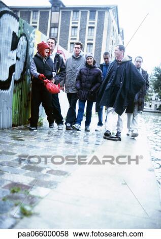 Group of young people hanging out near grafittied wall View Large Photo Image Stock Photo - Group of young people hanging out near grafittied wall. Fotosearch