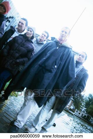 Stock Photo - Group of young people on sidewalk, tilt. Fotosearch