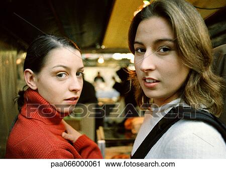Two young women in store, looking at camera, head and shoulders, close-up. View Large Photo Image Stock Image - Two young women in store, looking at camera, head and shoulders, close-up.. Fotosearch