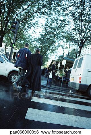Young couple walking on pedestrian crossing, rear view View Large Photo Image Stock Photograph - Young couple walking on pedestrian crossing, rear view. Fotosearch
