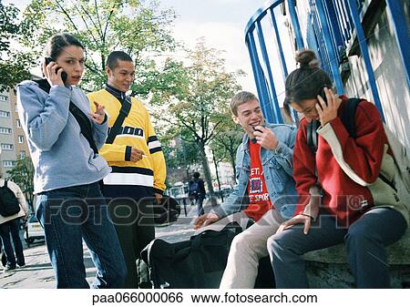 Young people hanging out together outside. View Large Photo Image Stock Photograph - Young people hanging out together outside.. Fotosearch