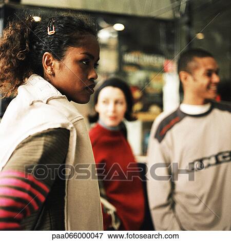 Young people standing in front of shop View Large Photo Image Stock Photo - Young people standing in front of shop. Fotosearch