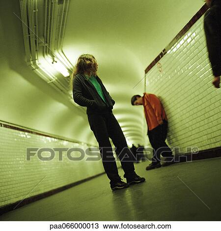 Young people standing in subway corridor View Large Photo Image Stock Image - Young people standing in subway corridor. Fotosearch
