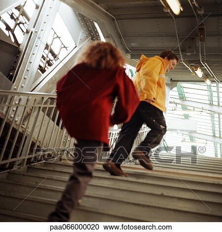 Young people walking up stairs in elevated subway station View Large Photo Image Stock Image - Young people walking up stairs in elevated subway station. Fotosearch