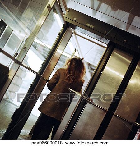 Young woman walking through subway station doorway, view from rear. View Large Photo Image Stock Photo - Young woman walking through subway station doorway, view from rear.. Fotosearch