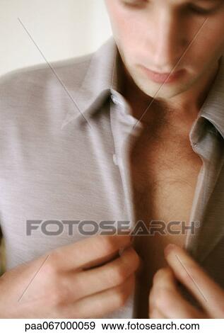 Man buttoning shirt, close-up, blurred. View Large Photo Image Stock Photo - Man buttoning shirt, close-up, blurred.. Fotosearch