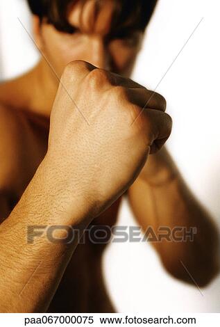 Stock Photography - Man holding up fists, close-up. Fotosearch