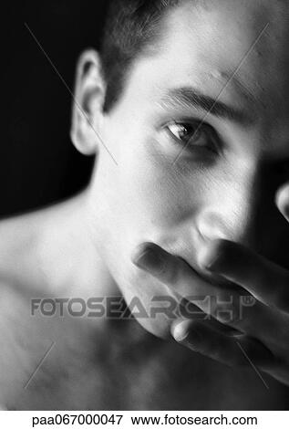 Man sucking on side of finger, looking at camera, blurred, black and white. View Large Photo Image Stock Photo - Man sucking on side of finger, looking at camera, blurred, black and white.. Fotosearch