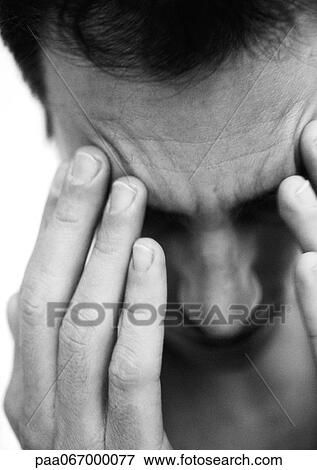 Man touching forehead with fingers, close-up, black and white. View Large Photo Image Stock Photo - Man touching forehead with fingers, close-up, black and white.. Fotosearch