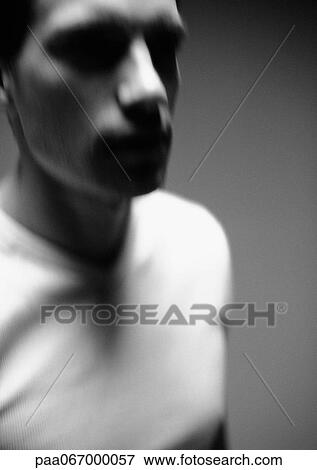 Stock Photo - Man wearing t-shirt, head and shoulders, close-up, blurred, black and white.. Fotosearch