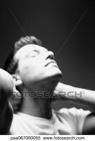 Man with hands behind neck, tilting head back, close-up, blurred, black and white. View Large Photo Image Stock Photography - Man with hands behind neck, tilting head back, close-up, blurred, black and white.. Fotosearch