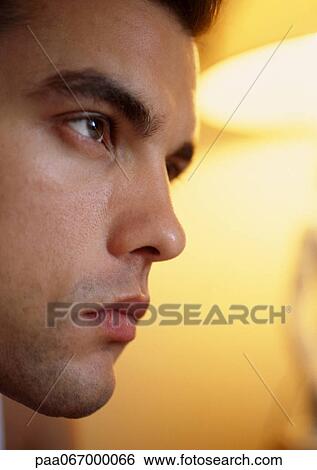 Man's face, side view, close-up, lamp in background View Large Photo Image Stock Photograph - Man's face, side view, close-up, lamp in background. Fotosearch