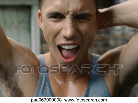 Sweaty man standing with arms up and mouth open, close-up, blurred. View Large Photo Image Stock Photo - Sweaty man standing with arms up and mouth open, close-up, blurred.. Fotosearch