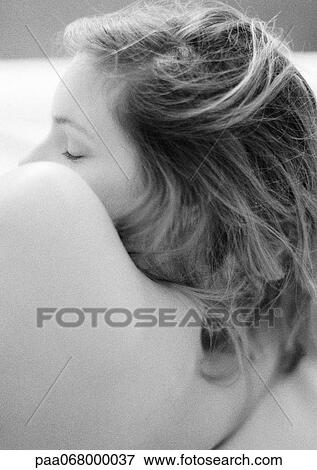 Stock Photo - Woman lying on side, close-up of bare back, shoulder and head, black and white.. Fotosearch