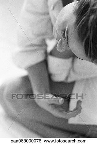Woman sitting on knees bending to the side, close-up, black and white. View Large Photo Image Stock Photograph - Woman sitting on knees bending to the side, close-up, black and white.. Fotosearch