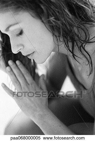 Stock Photography - Woman touching wet hair with hands, black and white.. Fotosearch