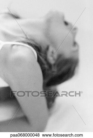Stock Photo - Woman with head back and mouth open, close-up, black and white.. Fotosearch