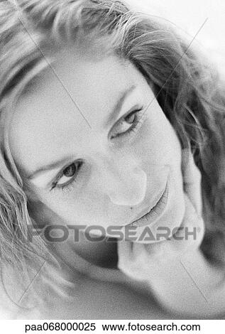 Stock Photography - Woman's face, chin under hand, close-up, black and white portrait.. Fotosearch