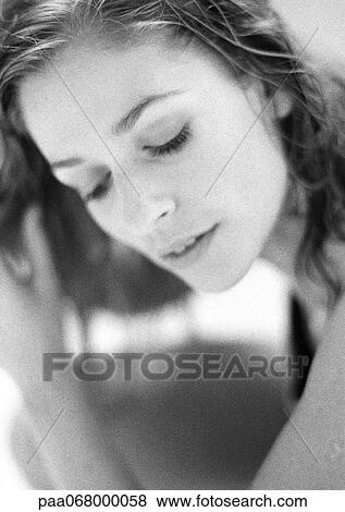 Stock Photo - Woman's face with eyes lowered, close-up, black and white.. Fotosearch