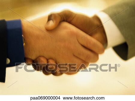 Blurred close-up of handshake. View Large Photo Image Picture - Blurred close-up of handshake.. Fotosearch