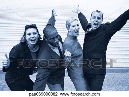 Stock Image - Business people making celebratory gestures, black and white, cool toned.. Fotosearch