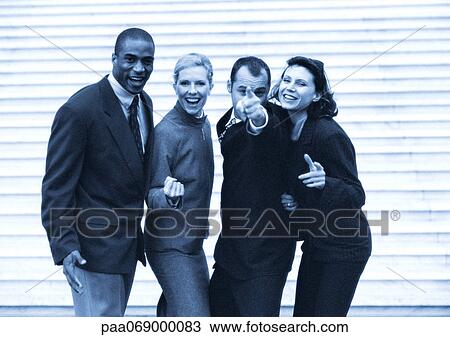 Stock Image - Business people posing, black and white, cool toned.. Fotosearch