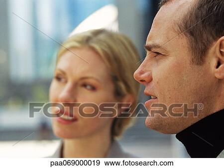 Businessman and woman, looking away from camera, close-up View Large Photo Image Stock Photo - Businessman and woman, looking away from camera, close-up. Fotosearch