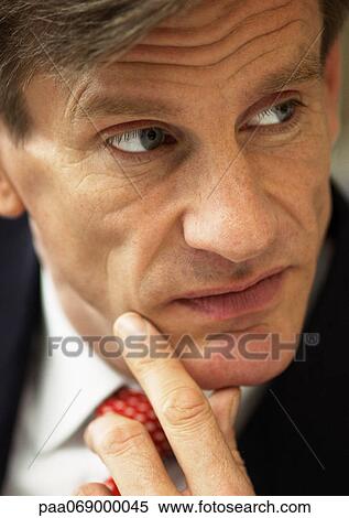 Businessman, fingers to chin, close-up portrait. View Large Photo Image Stock Photography - Businessman, fingers to chin, close-up portrait.. Fotosearch