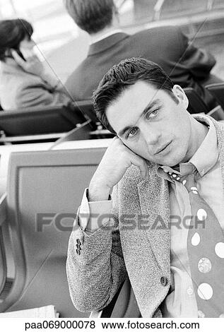 Businessman sitting in airport lounge, black and white. View Large Photo Image Stock Photo - Businessman sitting in airport lounge, black and white.. Fotosearch