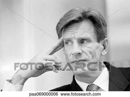 Businessman with fingers at temple, looking away, close-up, black and white. View Large Photo Image Stock Photograph - Businessman with fingers at temple, looking away, close-up, black and white.. Fotosearch