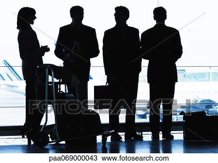 Group of business people standing inside airport, silhouette. View Large Photo Image Stock Image - Group of business people standing inside airport, silhouette.. Fotosearch