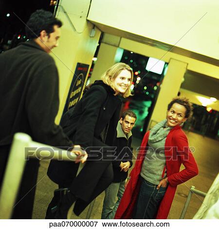 Group of people standing around rail View Large Photo Image Stock Photo - Group of people standing around rail. Fotosearch