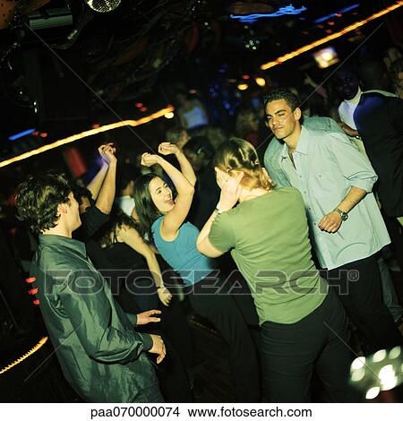 Group of young people dancing in nightclub. View Large Photo Image Picture - Group of young people dancing in nightclub.. Fotosearch