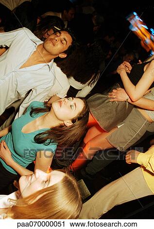 Group of young people dancing in nightclub View Large Photo Image Stock Image - Group of young people dancing in nightclub. Fotosearch
