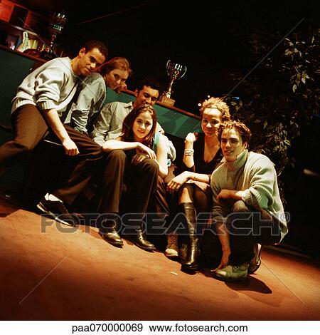 Group of young people sitting in front of trophy, portrait. View Large Photo Image Stock Photo - Group of young people sitting in front of trophy, portrait.. Fotosearch