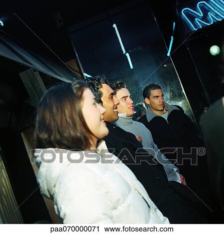 Group of young people standing, looking in same direction. View Large Photo Image Stock Image - Group of young people standing, looking in same direction.. Fotosearch
