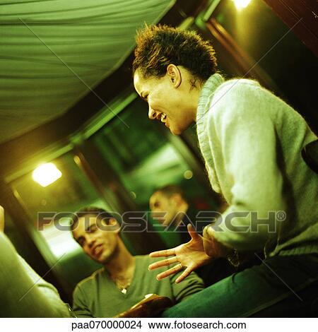 Group of young people, teenage girl in foreground smiling, low angle view View Large Photo Image Picture - Group of young people, teenage girl in foreground smiling, low angle view. Fotosearch