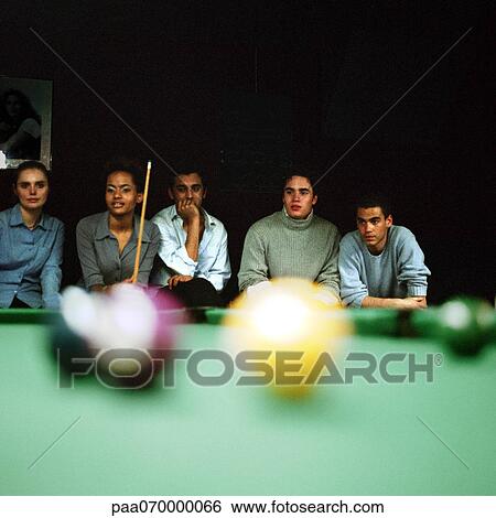 Group of young people watching a pool game, pool table blurred in foreground View Large Photo Image Stock Photograph - Group of young people watching a pool game, pool table blurred in foreground. Fotosearch