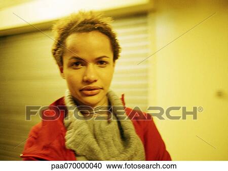 Stock Image - Teenage girl looking at camera, portrait.. Fotosearch