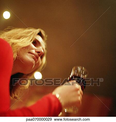Woman holding wine glass, portrait, low angle view. View Large Photo Image Stock Photo - Woman holding wine glass, portrait, low angle view.. Fotosearch