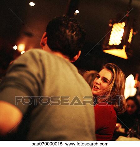 Young man and woman sitting and talking in cafe View Large Photo Image Stock Photography - Young man and woman sitting and talking in cafe. Fotosearch