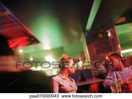 Young man and woman talking in bar View Large Photo Image Stock Image - Young man and woman talking in bar. Fotosearch