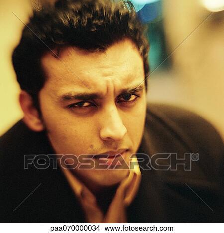 Young man looking at camera, close-up, portrait. View Large Photo Image Picture - Young man looking at camera, close-up, portrait.. Fotosearch