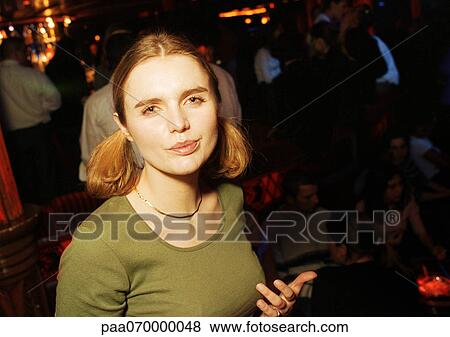 Young woman in bar looking at camera, portrait. View Large Photo Image Stock Photo - Young woman in bar looking at camera, portrait.. Fotosearch