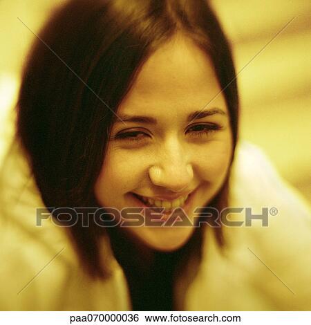 Stock Photograph - Young woman laughing, close-up, portrait.. Fotosearch