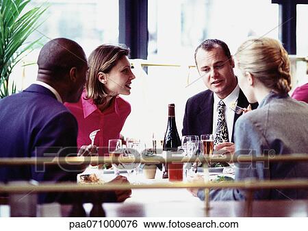 Business people sitting at table, eating, close up. View Large Photo Image Stock Photograph - Business people sitting at table, eating, close up.. Fotosearch