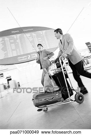 Businessman and businesswoman running through airport terminal, blurred, b&w. View Large Photo Image Stock Photo - Businessman and businesswoman running through airport terminal, blurred, b&w.. Fotosearch