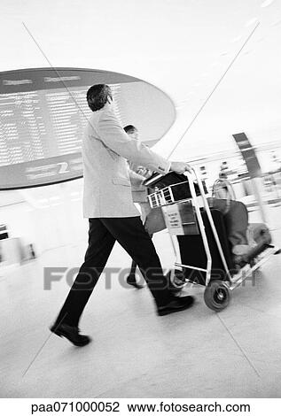 Businessman walking through terminal, blurred b&w. View Large Photo Image Stock Image - Businessman walking through terminal, blurred b&w.. Fotosearch
