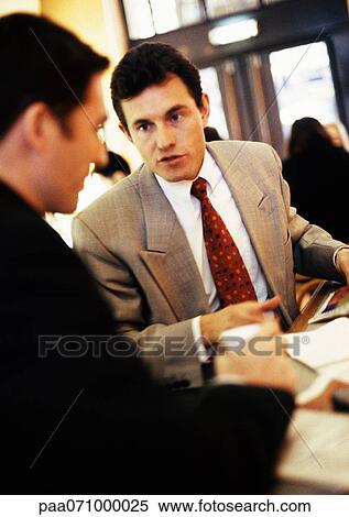 Businessmen talking together, close-up View Large Photo Image Stock Photography - Businessmen talking together, close-up. Fotosearch