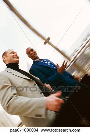 Picture - Businessmen walking together, blurred.. Fotosearch